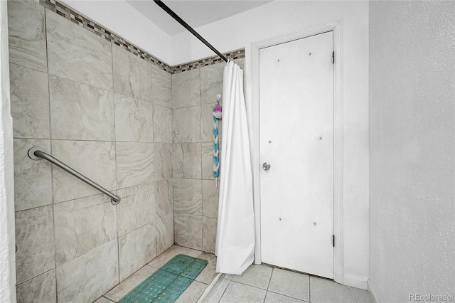 bathroom with tile patterned flooring and curtained shower