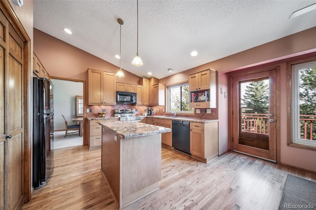 kitchen with light wood-style flooring, a textured ceiling, a sink, and black appliances