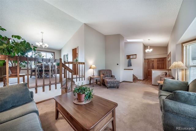 living area with plenty of natural light, vaulted ceiling, light colored carpet, and a notable chandelier