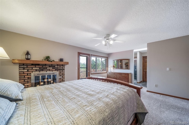 bedroom with ceiling fan, a brick fireplace, a textured ceiling, carpet, and baseboards