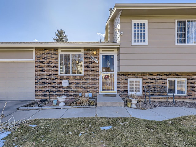 doorway to property with a garage