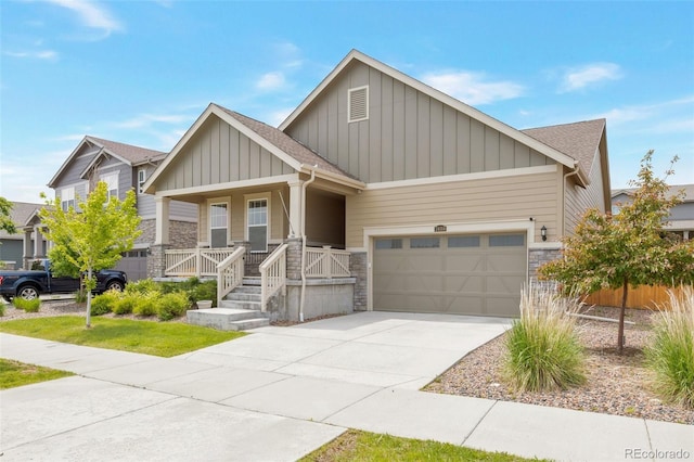 24314 E Ford Ave, Aurora, CO 80018 - view of front of property featuring board and batten siding, stone siding, a porch, concrete driveway, and a garage