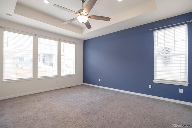 24314 E Ford Ave, Aurora, CO 80018 - empty room featuring a tray ceiling, a ceiling fan, carpet, and baseboards