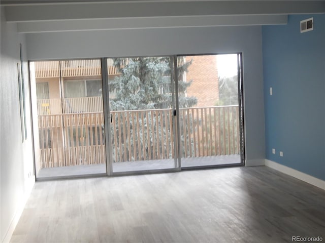 unfurnished room with hardwood / wood-style flooring