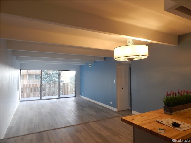 interior space featuring beamed ceiling and wood-type flooring