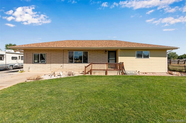 ranch-style home featuring a front yard