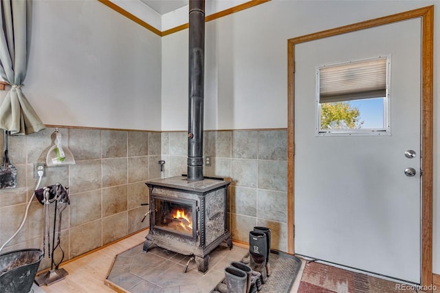 interior details with wood-type flooring and a wood stove