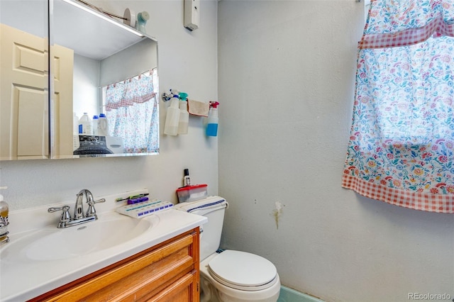 bathroom featuring vanity and toilet