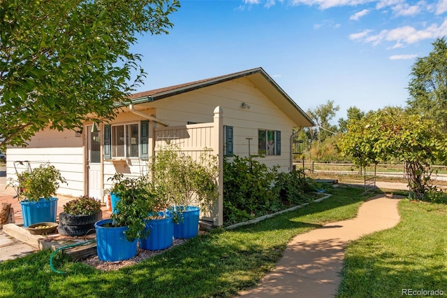 view of property exterior with a yard