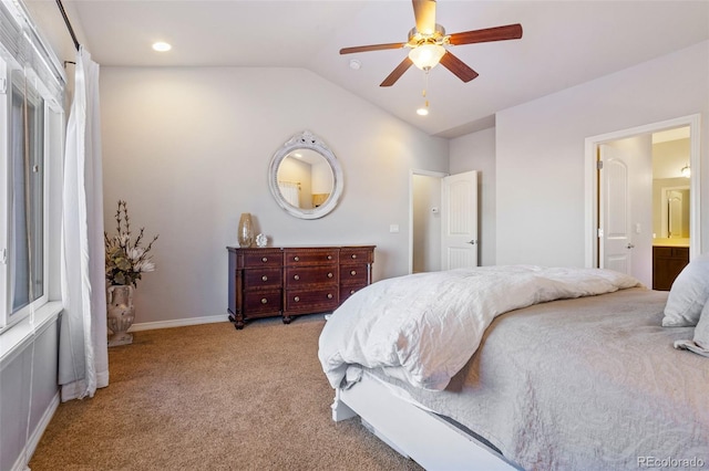 bedroom featuring vaulted ceiling, light colored carpet, ceiling fan, and ensuite bathroom