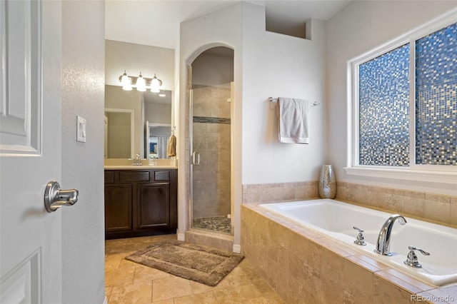 bathroom with vanity and separate shower and tub