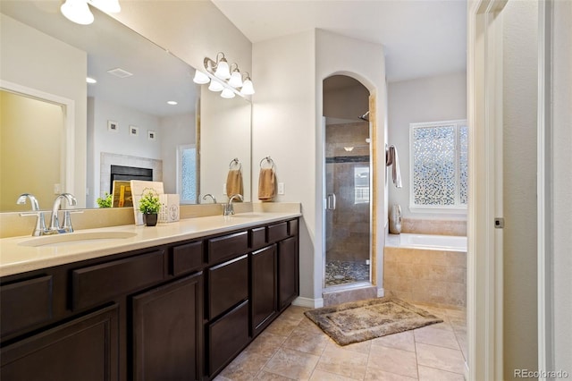 bathroom featuring vanity, independent shower and bath, and tile patterned flooring