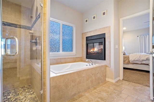 bathroom with a fireplace and shower with separate bathtub