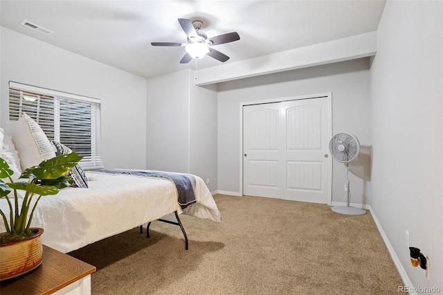 bedroom with a closet, ceiling fan, and carpet