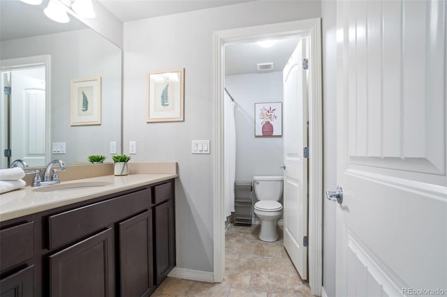 bathroom with vanity, a shower with shower curtain, and toilet