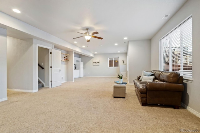 living room with light colored carpet and ceiling fan