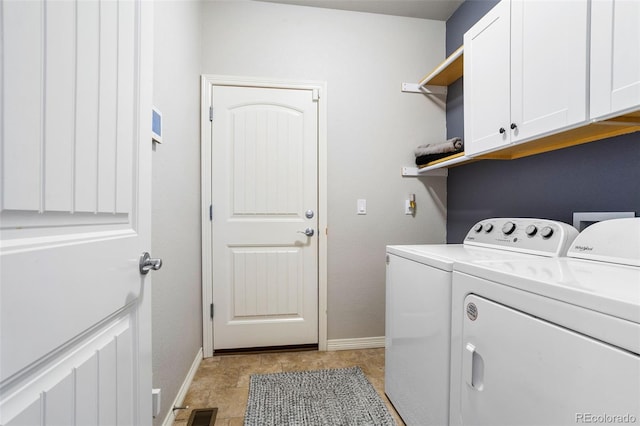 clothes washing area with cabinets, separate washer and dryer, and light tile patterned floors