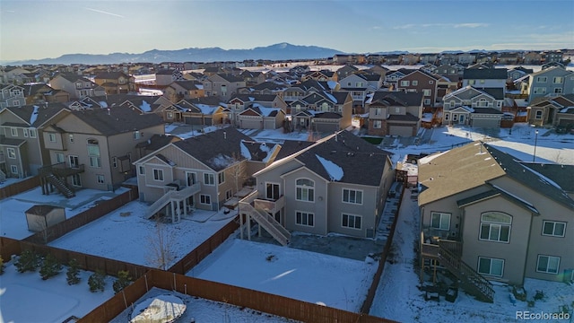 snowy aerial view featuring a mountain view