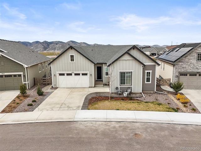 8985 Chalk Creek Pl, Littleton, CO 80125 - view of front of home featuring board and batten siding, concrete driveway, and a mountain view