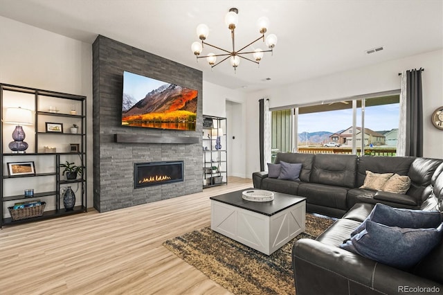 8985 Chalk Creek Pl, Littleton, CO 80125 - living area with wood finished floors, a chandelier, and a fireplace