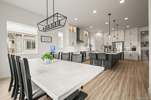 8985 Chalk Creek Pl, Littleton, CO 80125 - dining room featuring recessed lighting, light wood-style flooring, and a chandelier