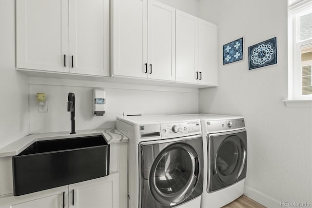 8985 Chalk Creek Pl, Littleton, CO 80125 - laundry room featuring cabinet space, washer and dryer, and healthy amount of natural light