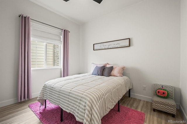 8985 Chalk Creek Pl, Littleton, CO 80125 - bedroom with wood finished floors, baseboards, and a ceiling fan