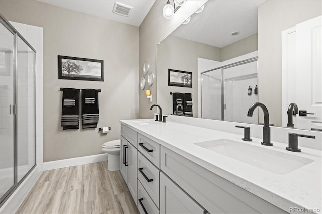 8985 Chalk Creek Pl, Littleton, CO 80125 - full bathroom featuring a stall shower, double vanity, toilet, and baseboards
