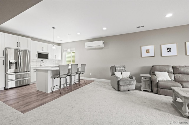 8985 Chalk Creek Pl, Littleton, CO 80125 - living area featuring recessed lighting, a wall mounted air conditioner, carpet flooring, baseboards, and wood finished floors