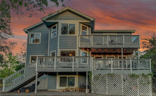 5457 S Valdai St, Aurora, CO 80015 - back of house at dusk with a balcony, stairway, and a deck