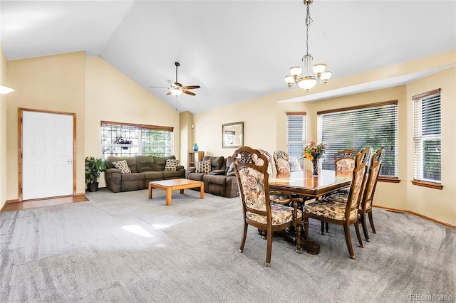 5457 S Valdai St, Aurora, CO 80015 - carpeted dining area with a ceiling fan, a chandelier, high vaulted ceiling, and baseboards