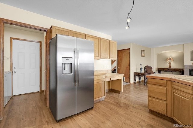 5457 S Valdai St, Aurora, CO 80015 - kitchen featuring stainless steel fridge with ice dispenser, light wood finished floors, tile countertops, and washer / dryer