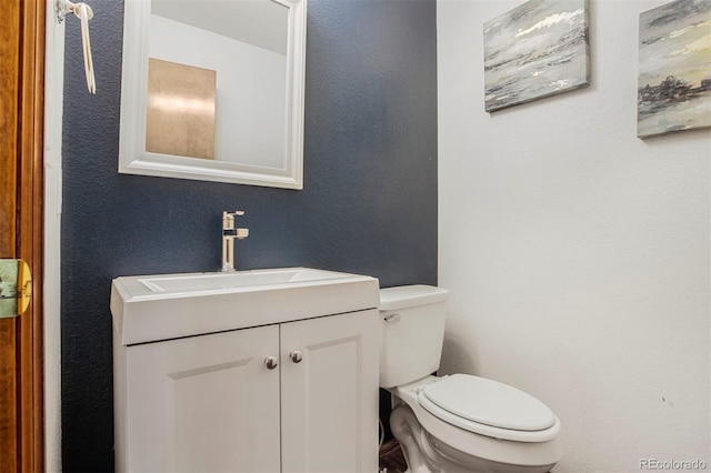 5457 S Valdai St, Aurora, CO 80015 - bathroom with vanity, toilet, and a textured wall