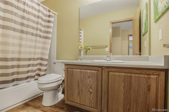 5457 S Valdai St, Aurora, CO 80015 - bathroom featuring toilet, vanity, wood finished floors, and shower / bath combo