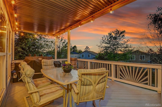5457 S Valdai St, Aurora, CO 80015 - deck at dusk featuring outdoor dining space