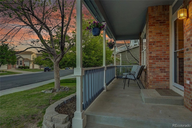 5457 S Valdai St, Aurora, CO 80015 - patio terrace at dusk featuring a porch