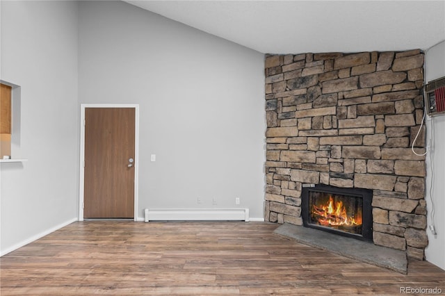 unfurnished living room featuring a stone fireplace, wood-type flooring, and a baseboard heating unit