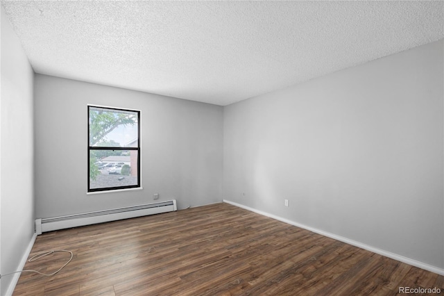 spare room featuring dark hardwood / wood-style flooring, a baseboard radiator, and a textured ceiling