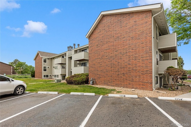 view of parking / parking lot with a lawn