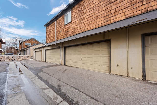 garage featuring aphalt driveway