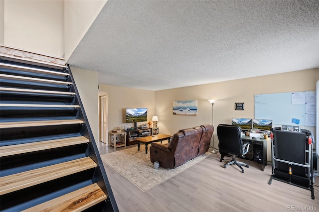 interior space with wood finished floors and a textured ceiling