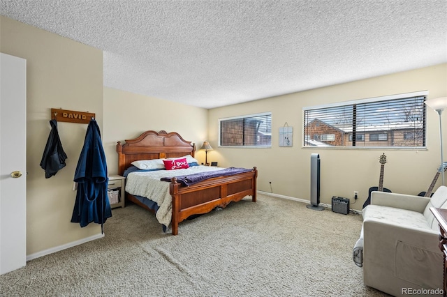 carpeted bedroom featuring a textured ceiling and baseboards