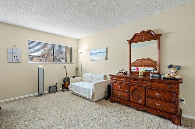 sitting room featuring baseboards, a textured ceiling, and carpet