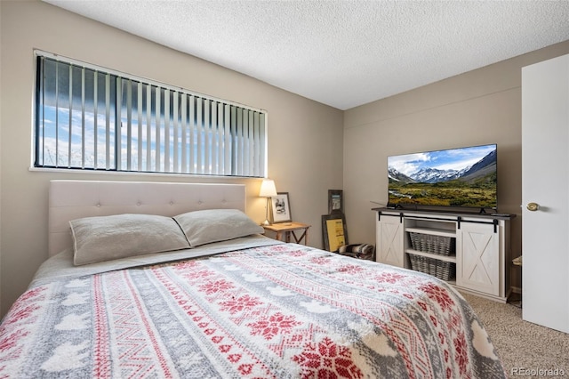 carpeted bedroom featuring a textured ceiling