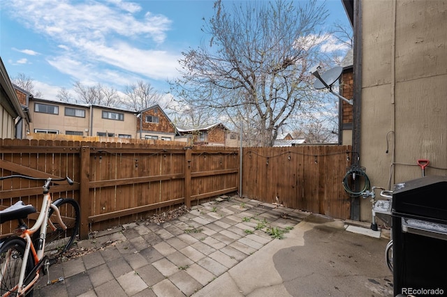 view of patio featuring area for grilling and fence