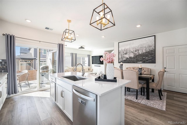 kitchen with a sink, decorative light fixtures, dishwasher, white cabinets, and dark wood-style flooring