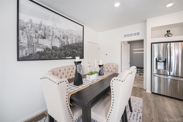 dining space with recessed lighting, visible vents, baseboards, and wood finished floors