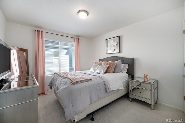 bedroom featuring baseboards and light carpet