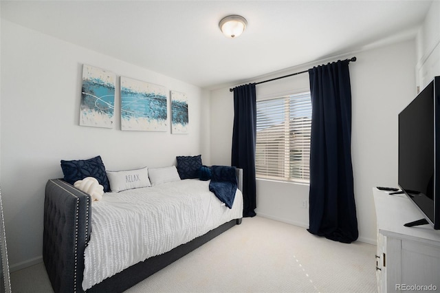 bedroom with carpet flooring and baseboards