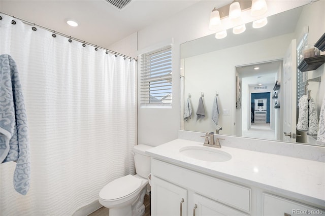 bathroom with a shower with shower curtain, visible vents, toilet, and vanity